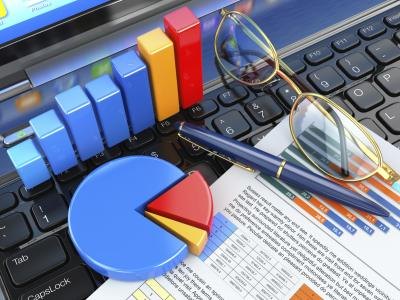 Data graphs on top of keyboard with glasses Data graphs on top of keyboard with glasses