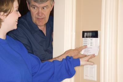 Technician and woman at thermostat