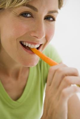 Woman eating a carrot