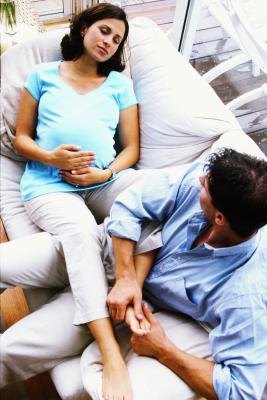 Pregnant woman and husband rubbing feet