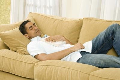 man sleeping on couch