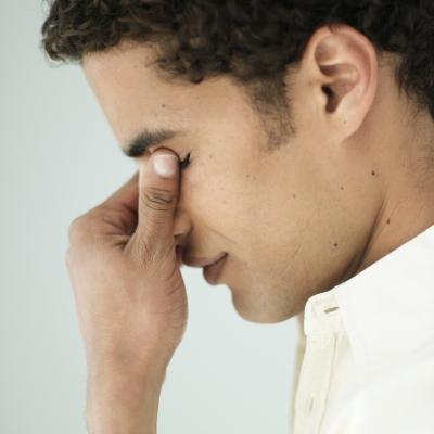 Man holding nose