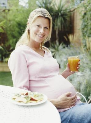 Pregnant woman drinking orange juice