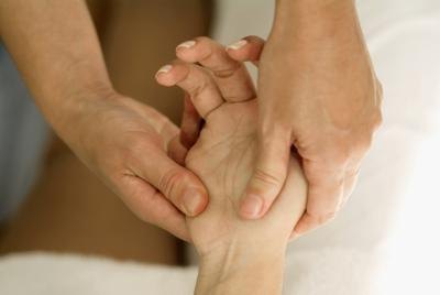 A woman gets her hand massaged