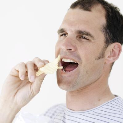 Man eating potato chips
