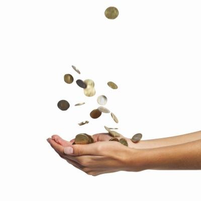 Woman catching coins in hands.