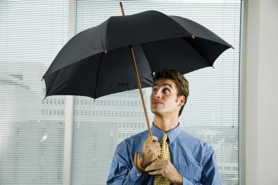 Office worker holding an open umbrella