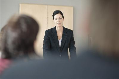 Woman speaking in front of a group.