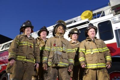 Firefighters near truck. Firefighters near truck.