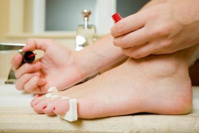 Similar to painting your toe nails, use toe separators to help keep your toes from curling towards the center