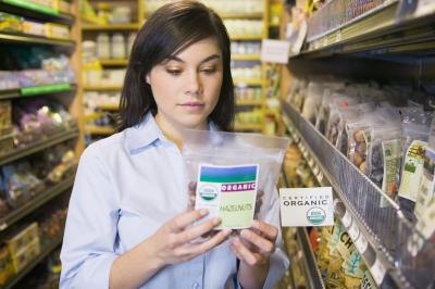 Woman reading food label in grocery store.
