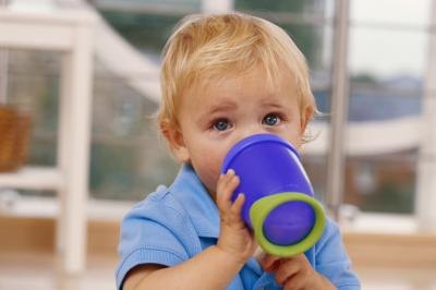 Baby boy drinking from sippy cup