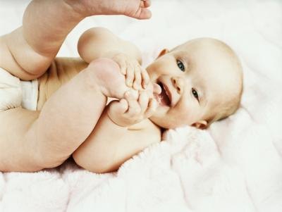 A baby naturally does Joyful Baby pose.