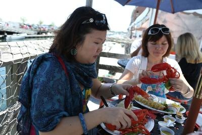 Tourists enjoy cooked lobster in Portland, Maine