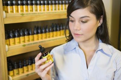 Woman reading a supplement label Woman reading a supplement label