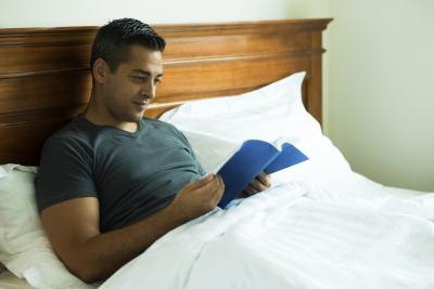 A man reading in bed