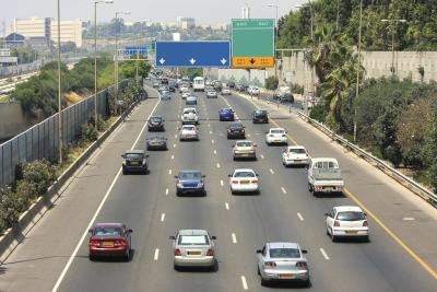 A wide shot of cars driving on a freeway