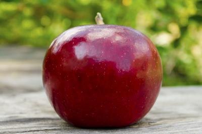 Close up of a ripe, red apple on a table