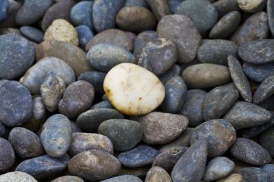 Stones sink because they displace less water than their weight.