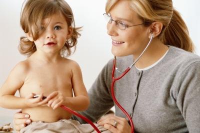 Pediatrician wearing stethoscope with toddler