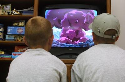 Boys watching movie on PlayStation console
