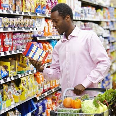 A man reading a nutritional label
