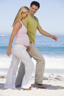 Pregnant woman walking with husband