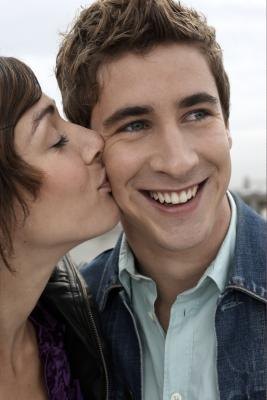 Woman kissing man on cheek