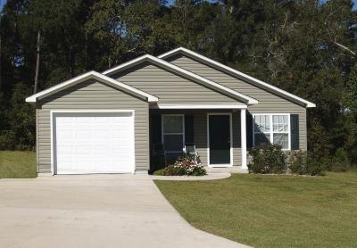 A curbside view of a home with gray siding and blue shutters.