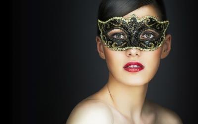 Young woman in a masquerade mask. Young woman in a masquerade mask.