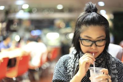 Woman drinking water in food court