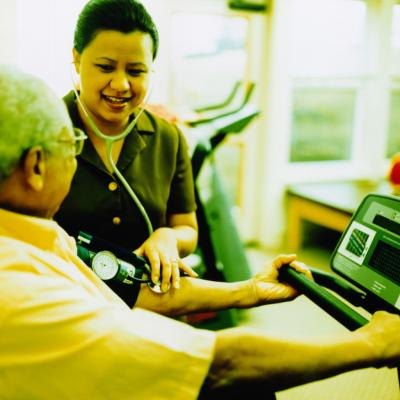 Nurse taking blood pressure of patient