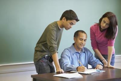 Teacher discussing results with two students