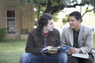 Student speaking with professor on campus.