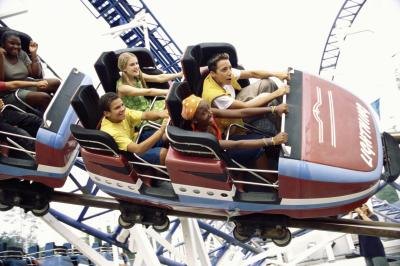 Teenage boys and girls on roller coaster ride