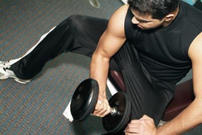Man exercising with dumbbells in the gym