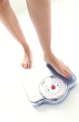 Woman measuring her weight
