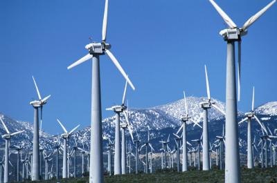 Several turbines spin at a windfarm.