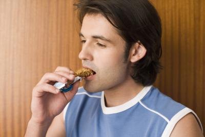 Man eating a granola bar