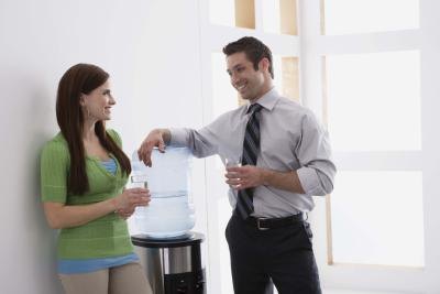 Coworkers talking at water cooler