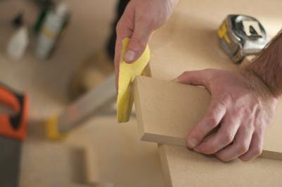 Hand sanding a piece of wood