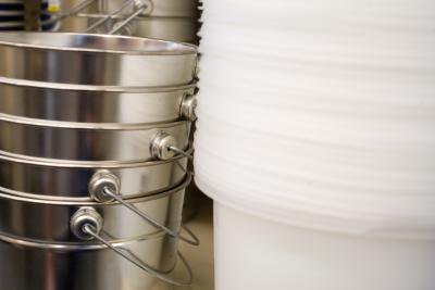 Place a bucket under the water hose at the back of the washer.