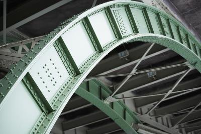 A steel arch supports a roadway.
