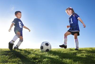Boy and girl playing soccer