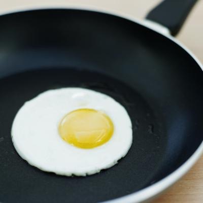 An egg fries in a pan.