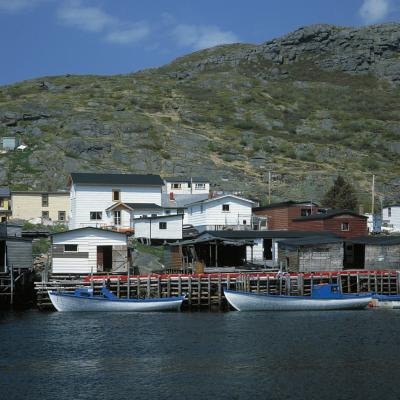Two docked boats in a coastal fishing town.