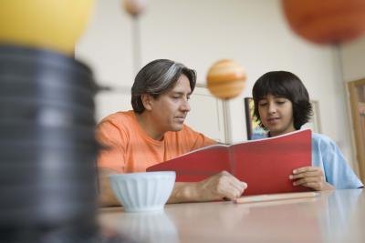 Father helping son with science project.