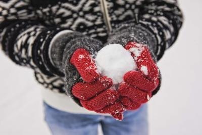 Man holding snow ball in hands