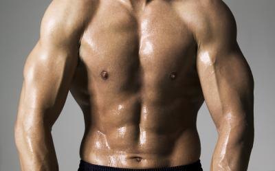 A man flexes his chest and arms.