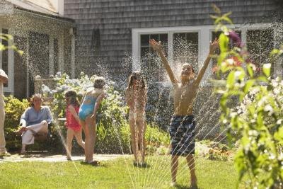 Children running in sprinkler